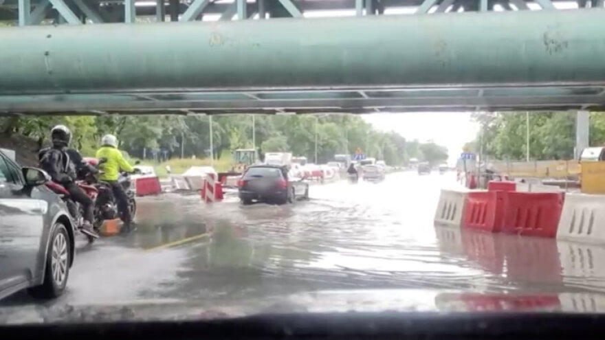 After the downpour in Warsaw, cars drove through a huge puddle